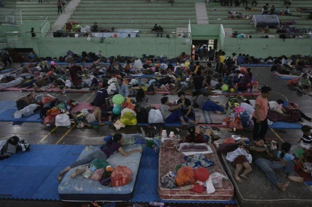 Villagers rests at a temporary evacuation centre, for people living near Mount Agung, a volcano on the highest alert level, inside a sports arena in Klungkung, on the resort island of Bali, Indonesia, 24 September 2017 in this photo taken by Antara Foto.