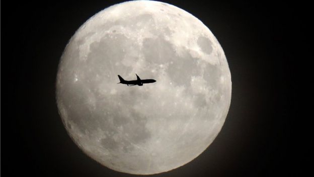 Luna llena con un avión.