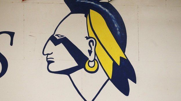A Native American mascot painted on a wall