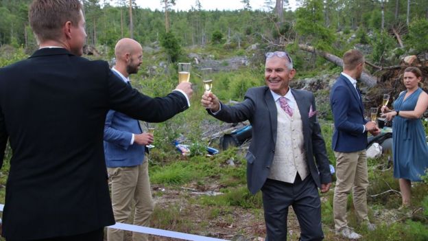 Wedding guests toast across the border
