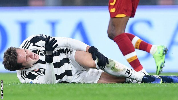 Federico Chiesa lies on the pitch injured