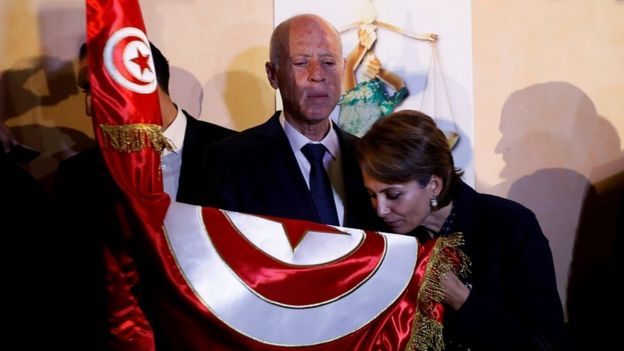Tunisian presidential candidate Kais Saied and his wife Ichraf Chebil react after exit poll results were announced in Tunis, October 13, 2019
