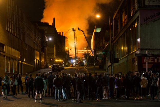 Crowds look on as firefighters tackle the blaze