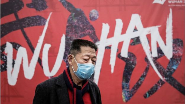 A man wears a mask while walking in the street on January 22, 2020 in Wuhan, Hubei province, China