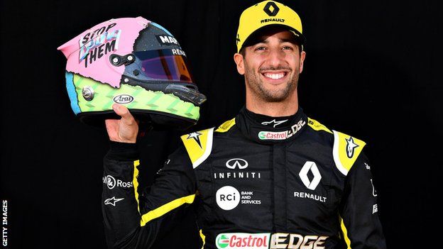 Daniel Ricciardo holds up his new helmet design