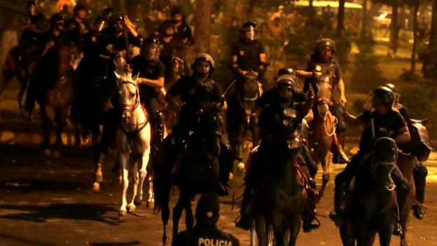 Police on horseback are seen during a demonstration against a possible change in law to allow for presidential re-election in front of the Congress building in Asuncion, Paraguay, March 31, 2017.