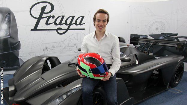 Britcar Endurance Championship driver and Racing Pride co-founder Richard Morris holds up his helmet while leaning against a car
