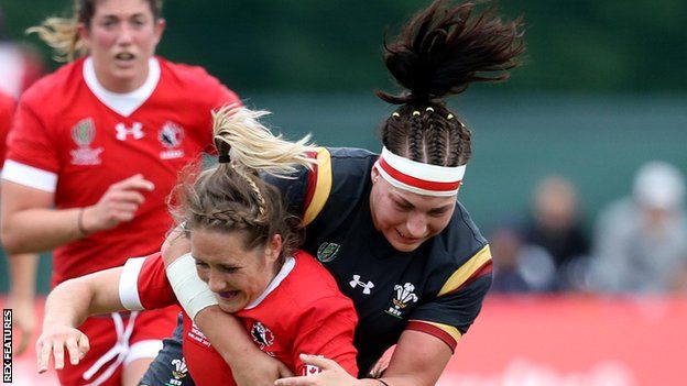 Amy Evans and Rachel Taylor of Wales tackle Canada's Lori Josephson