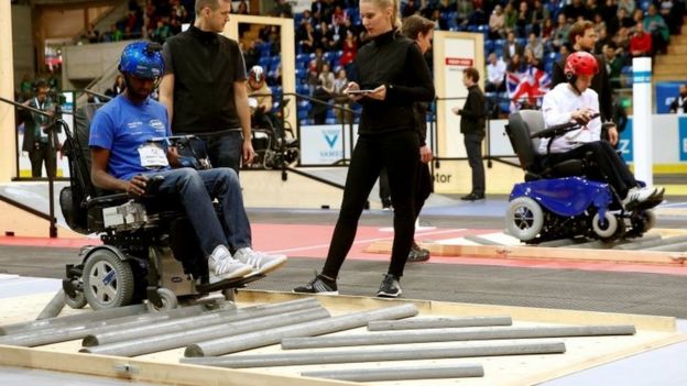 Sivashankar Sivakanthan and Yuri Larin compete in the powered wheelchair race