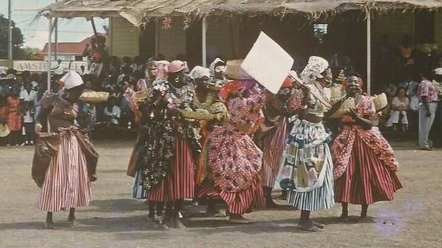 Women wearing plantation-era dresses attend the 1967 Carnival