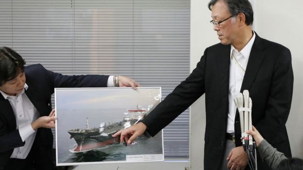 Kokuka Sangyo president Yutaka Katada points to a photograph of the tanker Kokuka Courageous (13 June)