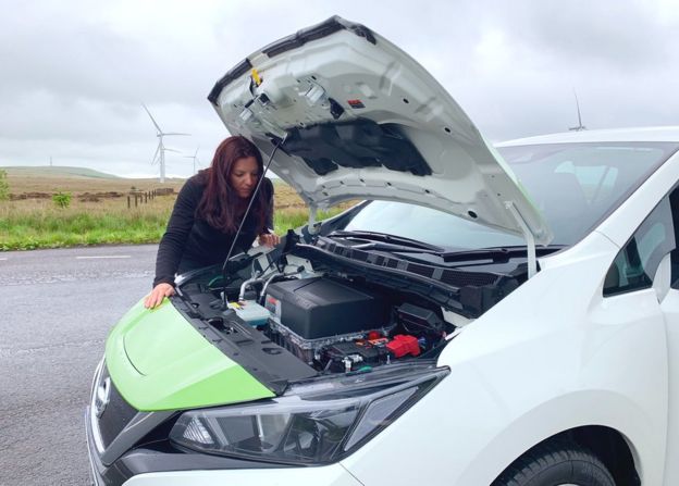 Angie Brown looking at the battery in an electric car