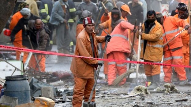 Afghan municipality workers at the scene of a suicide bomb attack in Kabul, Afghanistan, 27 January 2018.