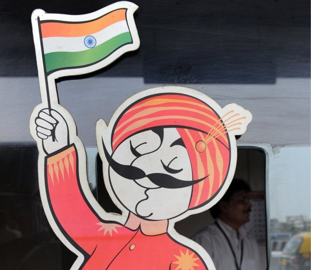 An employee is seen behind the ticket window of India's flagship carrier Air India displaying its logo the 'Maharaja' at the domestic airport in Mumbai on April 28, 2011.