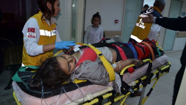 Injured girl is taken to hospital following a fire at a dormitory in Adana, southern Turkey, on November 29, 2016