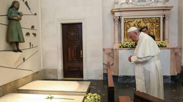 Pope Francis prays on the grave of Francisco Marto and Jacinta, two of the three shepherd children, at the Our Lady Rosario Cathedral in the Fatima Sanctuary, Portugal, 13 May 2017