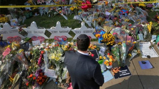 A man prays at a makeshift memorial outside the Tree of Life synagogue