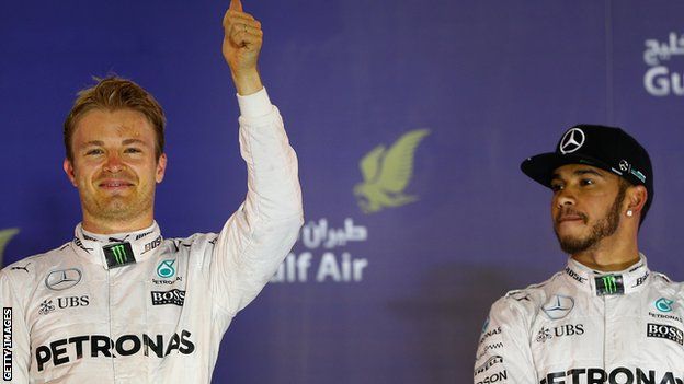 Nico Rosberg celebrates next to Lewis Hamilton on the podium