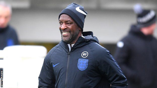 England coach Chris Powell smiles during a training session