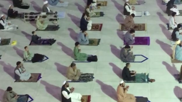 People social distancing while praying in a mosque