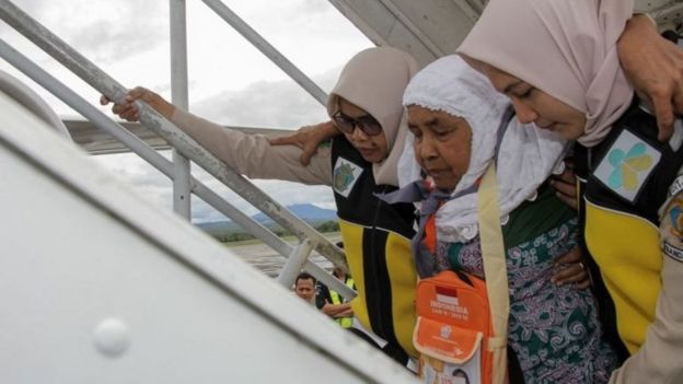 Seorang calon jemaah haji dipapah petugas saat keberangakatan sebelum pandemi covid-19.