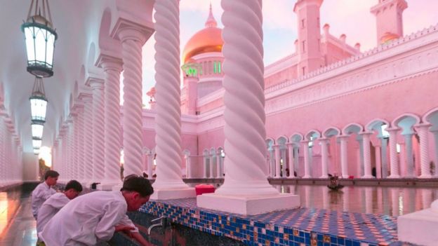 In this picture taken on April 1, 2019 children perform ablution before praying at the Sultan Omar Ali Saifuddien mosque in Bandar Seri Begawan