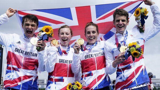Great Britain celebrate winning the inaugural triathlon mixed relay event at an Olympic Games