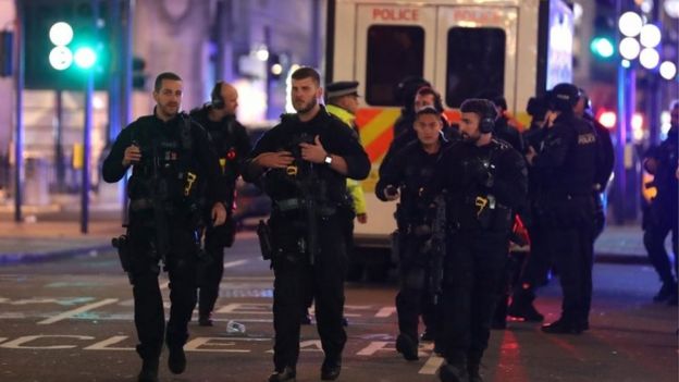 Armed police patrol along Oxford street