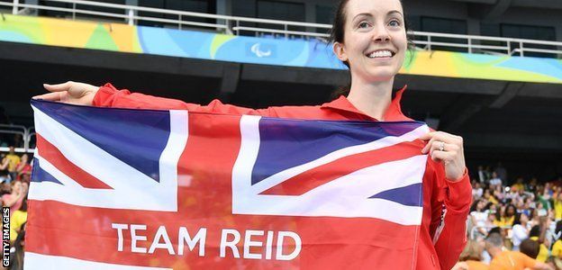 Long jumper Stef Reid holding a 'Team Reid' flag at the Rio Paralympics
