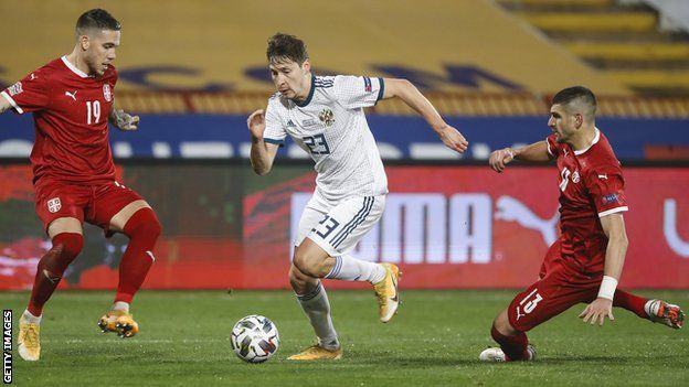 Mihailo Ristic (left) and Stefan Mitrovic (right) try to keep pace with Russia's Daler Kuzyaev in the Nations League game last November