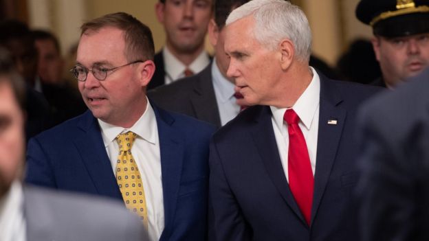 US Vice President Mike Pence and Mick Mulvaney walk between meetings