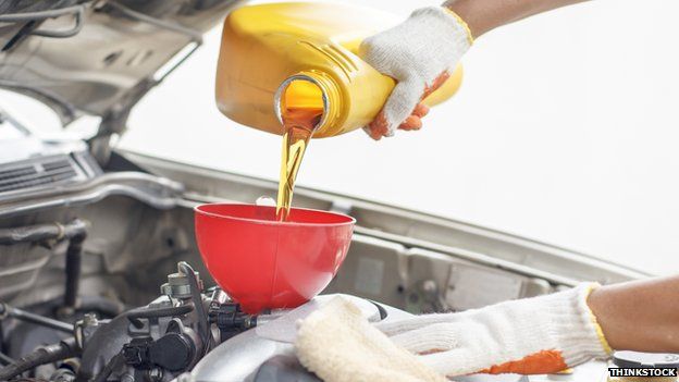 mechanic refills oil