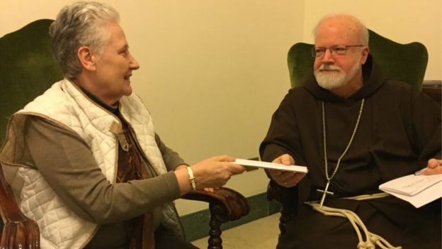 Marie Collins, a former member of the Pontifical Council on the Abuse of Minors, handing a letter to Cardinal Sean O’Malley, the Archbishop of Boston, 12 April 2015
