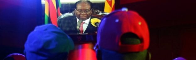 People watch as Zimbabwean President Robert Mugabe addresses the nation on television, at a bar in Harare, Zimbabwe, November 19, 2017.