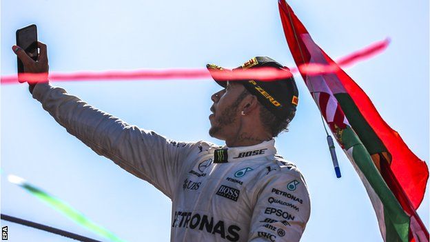 Lewis Hamilton taking a selfie on the Monza podium