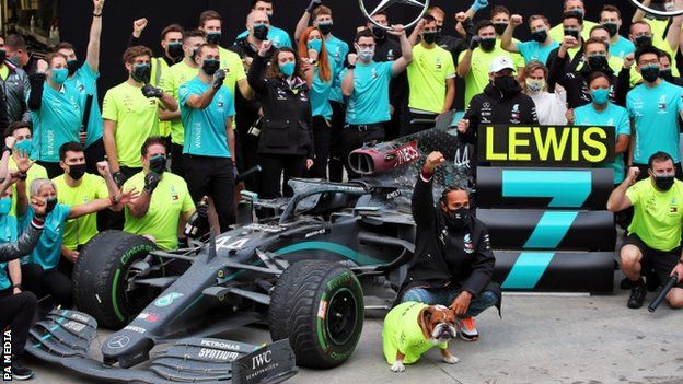Lewis Hamilton celebrates with the Mercedes team