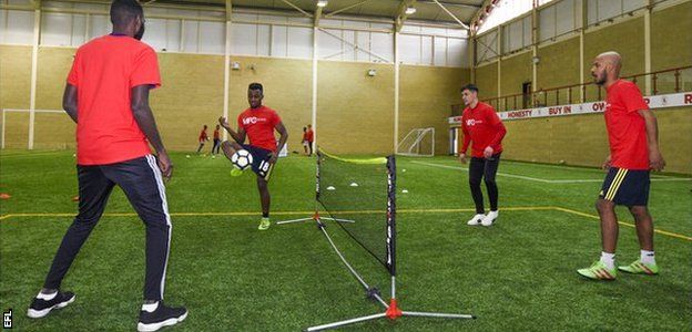 Middlesbrough midfielder Muhamed Besic, second from right, trains with refugee footballers who play for Club Together