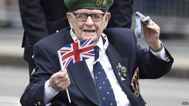Veteran waves union jack during the parade