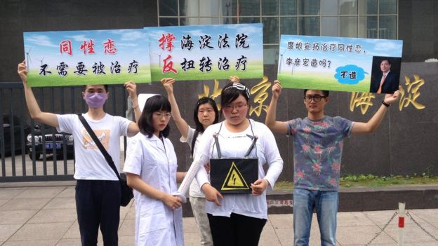 Gay activists stage a small protest outside courtroom on Thursday (7/31/14) where a gay man sued counselors for trying to 'cure' him of homosexuality with electric shock treatments