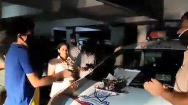 Vatsal Sharma cuts a cake while police officials sing to him