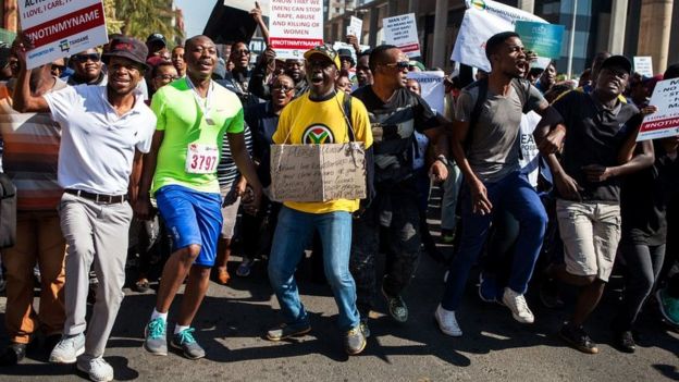 South African men gather during a march organized on May 20, 2017