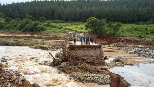 Timber company workers stand stranded on a damaged road on March 18, 2019, at Charter Estate, Chimanimani, eastern Zimbabwe