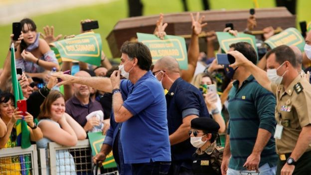 President Jair Bolsonaro greets supporters during an anti-quarantine protest in Brasilia, 17 May 2020