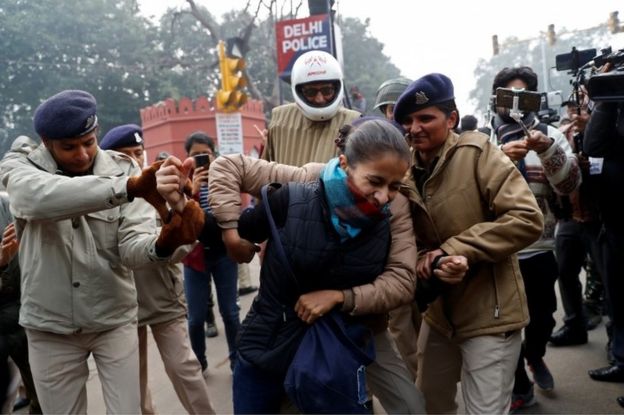 A demonstrator is detained during a protest against a new citizenship law, in Delhi, India, December 19, 2019.