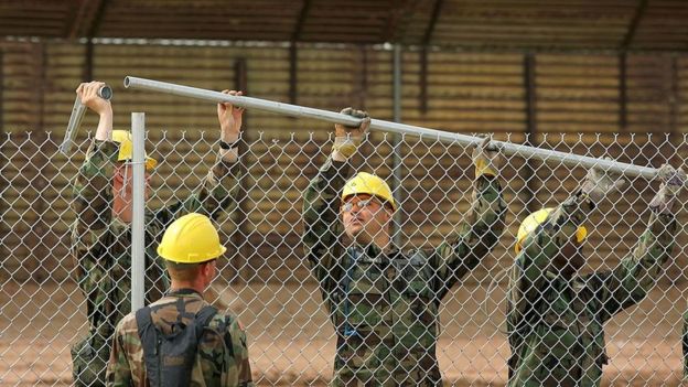 US Army Rangers erect a chain-link fence to further fortify the US/Mexico border