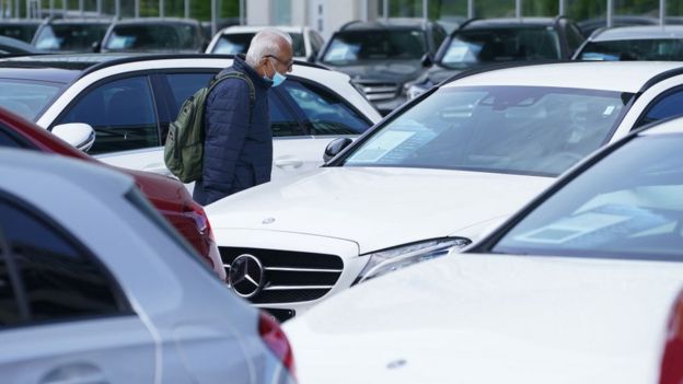 A man looking at cars for sale at a dealership in Germany on 5 May 2020