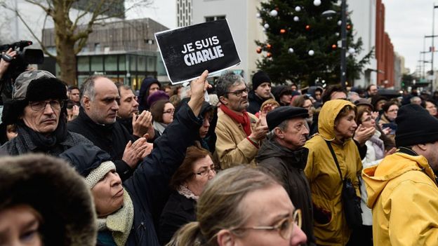 Mourners at a funeral for one of the Charlie Hebdo massacres