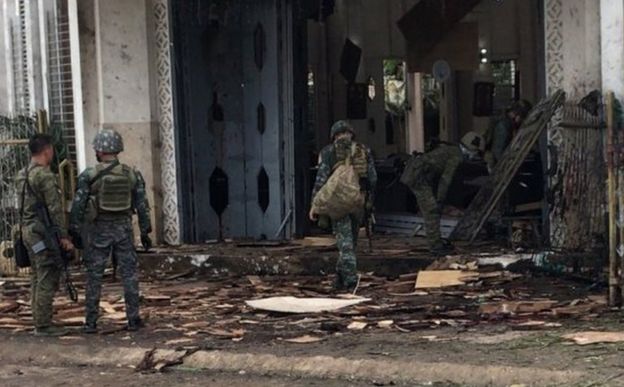 Soldiers gather evidence at the scene of two bomb attacks in Jolo. Photo: 27 January 2019