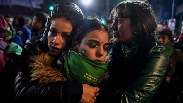 Pro-choice campaigners hug each other outside Argentina's parliament