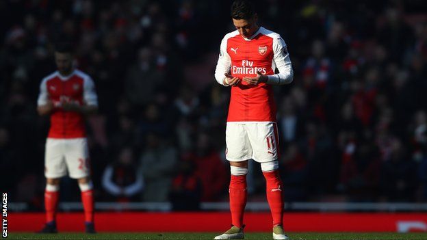 Arsenal's Mesut Ozil (right) prays prior to kick-off during the Premier League match between Arsenal and Burnley